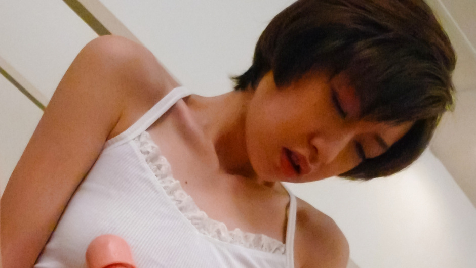 Short-haired Japanese woman Akina Hara tests her new realistic dildo.